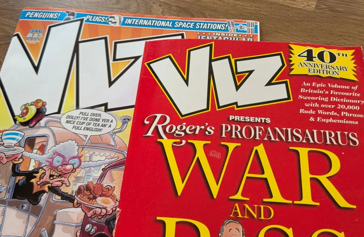 Viz Comic and a copy of Roger's Profanisaurus next to each other on a table for an article showing the problems with Google Live Transcribe