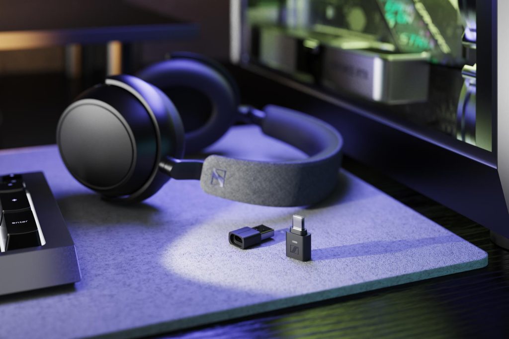 The Sennheiser BTD 700 on a purple table with headphones and a keyboard