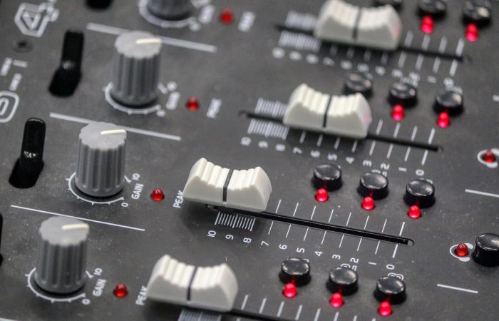 Buttons on a sound desk similar to one used by a sound engineer in a venue that could use Auracast