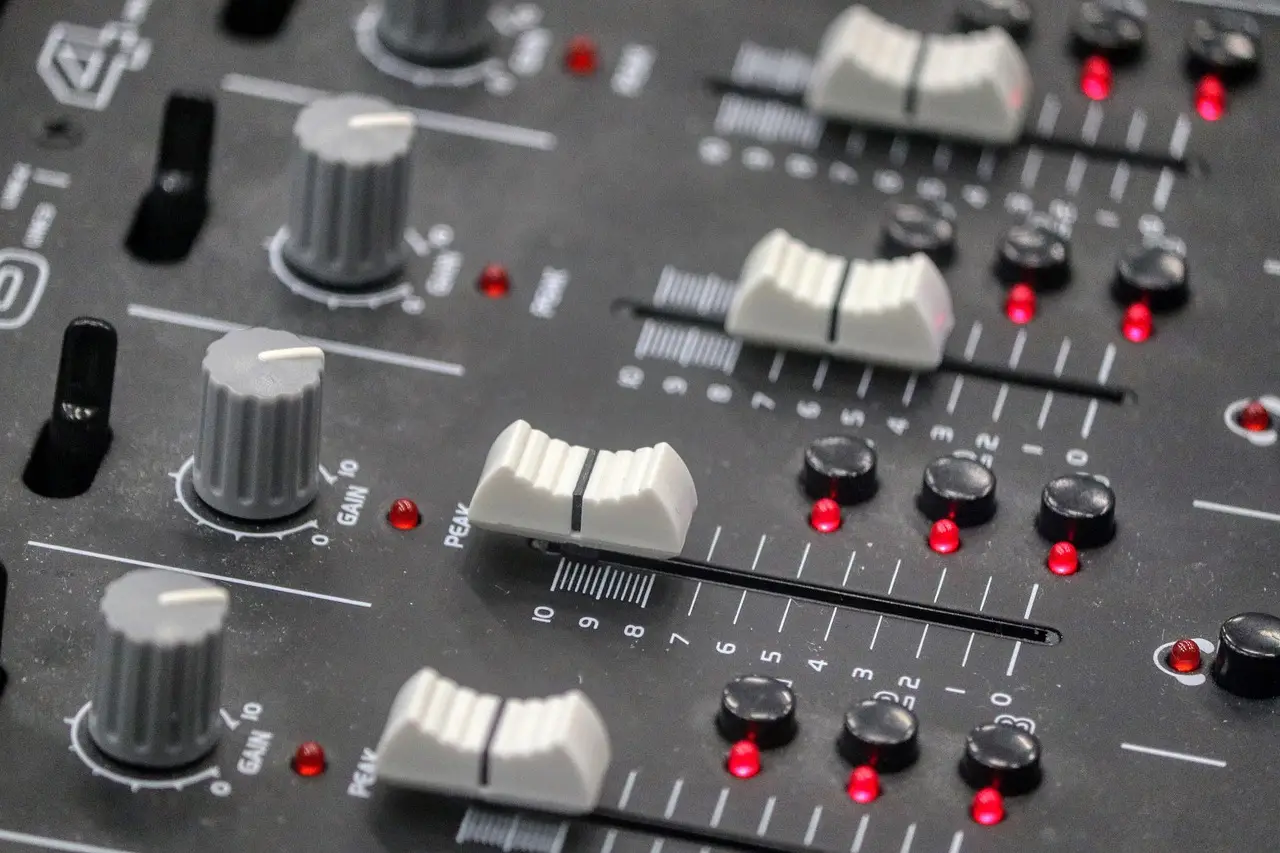 Buttons on a sound desk similar to one used by a sound engineer in a venue that could use Auracast