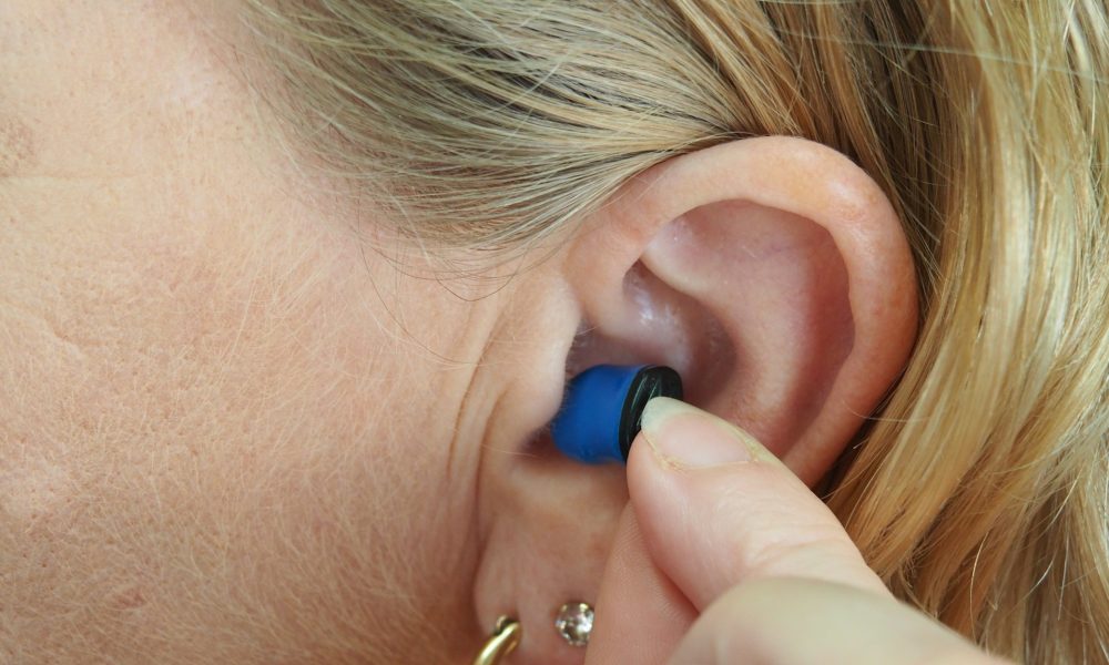 Why RNID is excited about Auracast – and what it thinks needs to happen for it to become THE standard A person inserting a hearing aid into their ear. We do not know if they have Auracast in the ear. the RNID wants to see Auracast adopted by hearing aid manufacturers