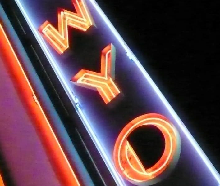 A neon sign with the letters WYO