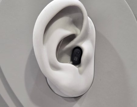 EUHA 2025: Oticon Zeal powers up with Auracast and next gen AI The Oticon Zeal on display at EUHA - it is situated in a 3D mock-up of an ear