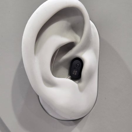 EUHA 2025: Oticon Zeal powers up with Auracast and next gen AI The Oticon Zeal on display at EUHA - it is situated in a 3D mock-up of an ear