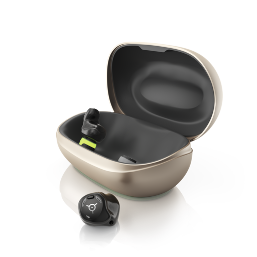 Phonak's Virto R Infinio hearing aids. One is out of the charging case, the other is in it