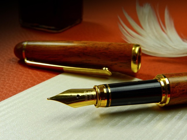 Contact Aurahear.co.uk by writing: a fountain pen on paper with a feather behind it