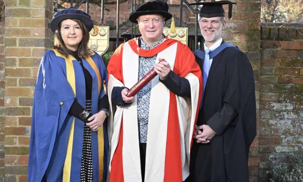 The University of Reading presented an honorary degree to Aurahear.co.uk's Phil Creighton (pictured centre). All three people are wearing ceremonial robes for an academic institution.