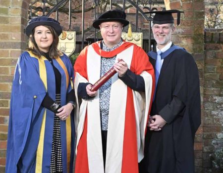 The University of Reading presented an honorary degree to Aurahear.co.uk's Phil Creighton (pictured centre). All three people are wearing ceremonial robes for an academic institution.