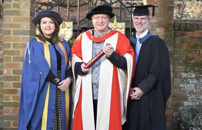 The University of Reading presented an honorary degree to Aurahear.co.uk's Phil Creighton (pictured centre). All three people are wearing ceremonial robes for an academic institution.