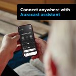 A man on his mobile phone using the My Starkey app to connect to an Auracast